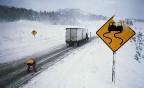 Funny Pictures of Skier Behind Truck On Icy Highway