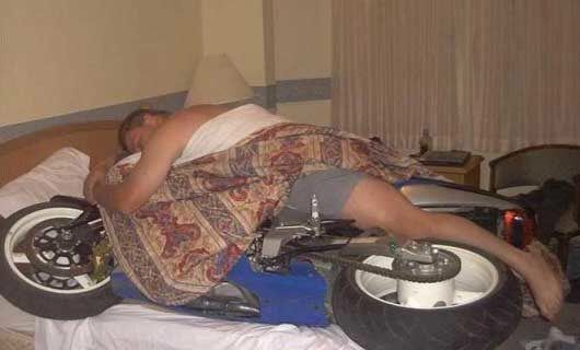 Funny Pictures of Man Sleeping With Motorcycle