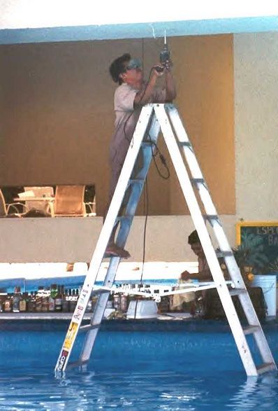 Funny Pictures of Worker on Aluminum Ladder in Pool
