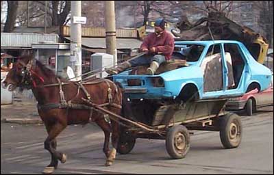 A funny picture of a horse pulling a car.