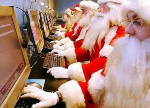 Funny pictures of Santas sitting At Computer