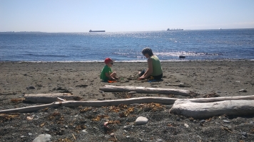 A grandma and grandson playing at the beach