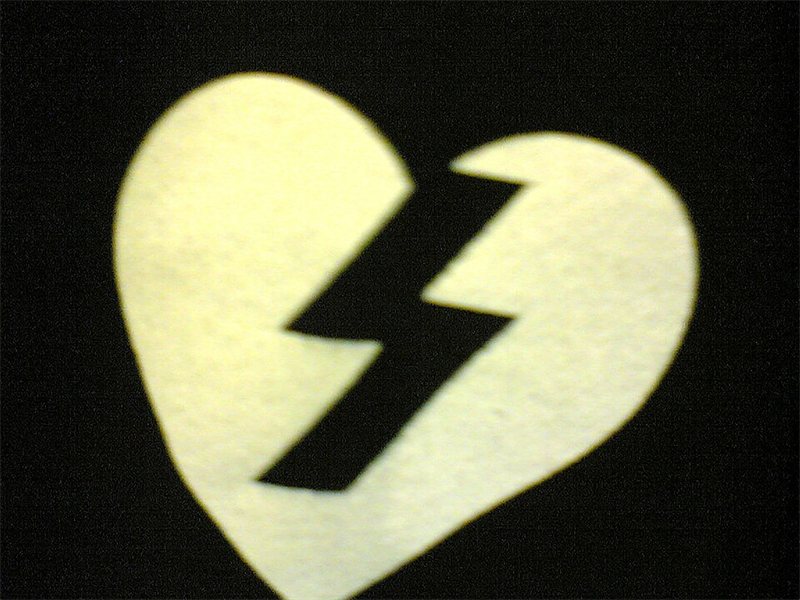 A white heart split by a lightning crack.