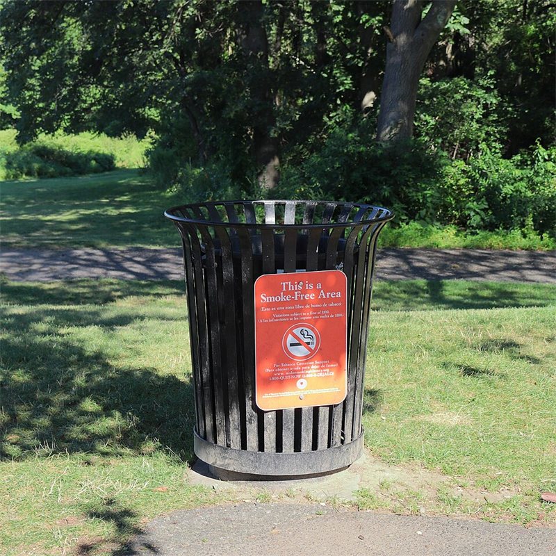 A garbage can in a park.