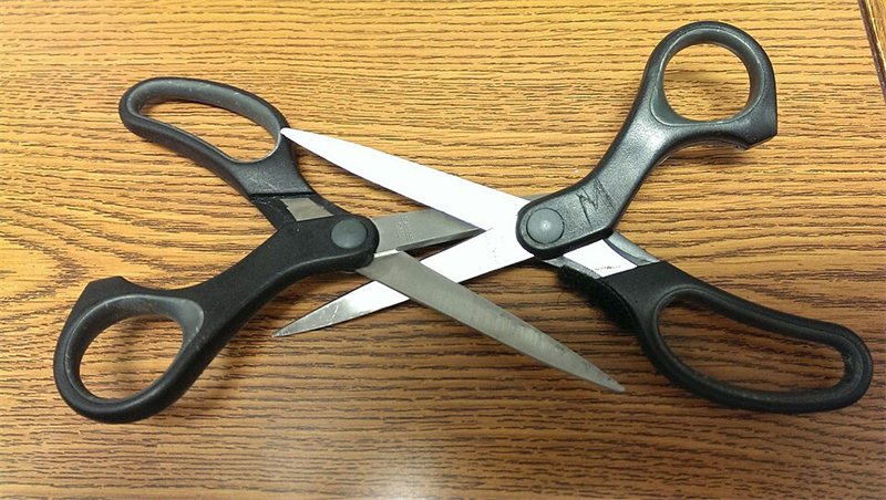 A pair of black-handled scissors.