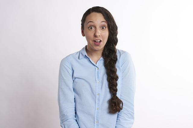 A woman with a long braid looking directly at us with a shocked expression.