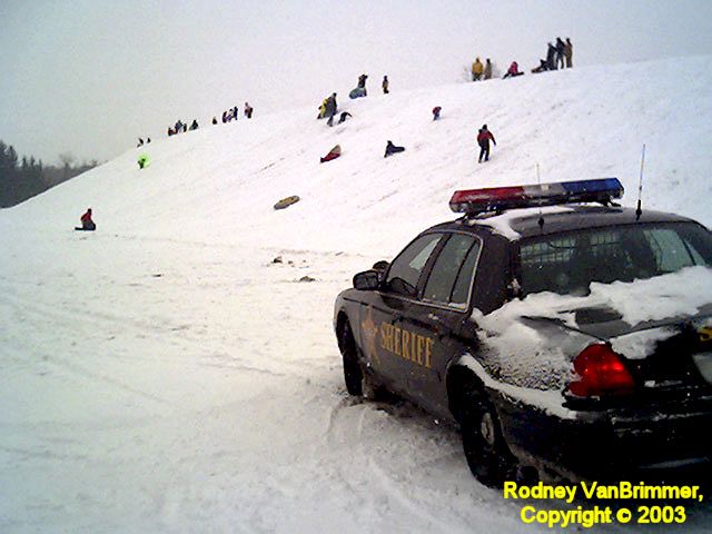Funny Pictures of Sheriff Watching Speeding Sledders