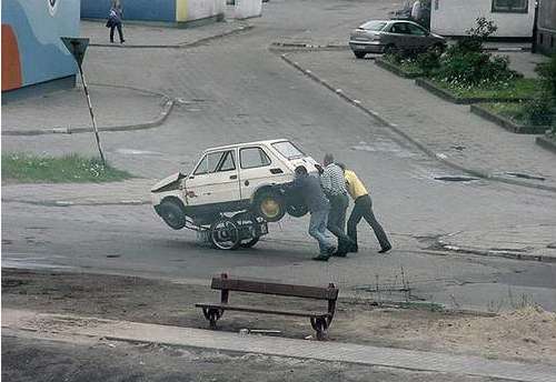 Funny Pictures of 3 Guys Pushing A Car Cart