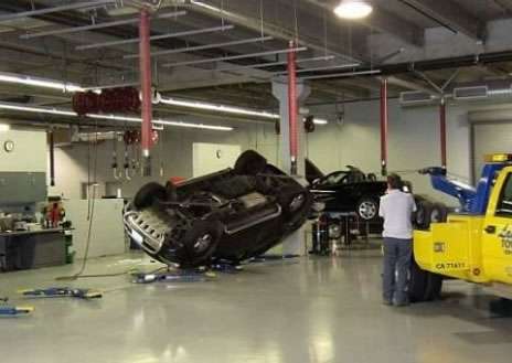 Funny Pictures of Car and Tow Truck in Auto Body Shop