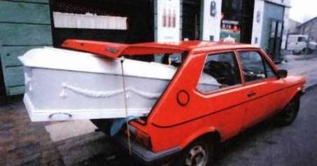 Funny Pictures of White Casket Sticking Out of Small Red Car