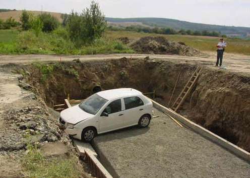 Funny Pictures of Car Crashed in Hole In Ground