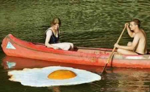Funny Pictures of of Fried Egg Floating By Canoe Couple