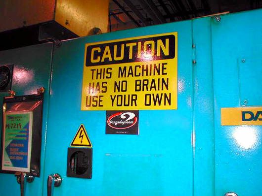 Funny Pictures of Caution Sign on Machine.