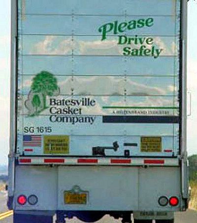 Funny Pictures of Drive Carefully Sign on a Casket Truck.