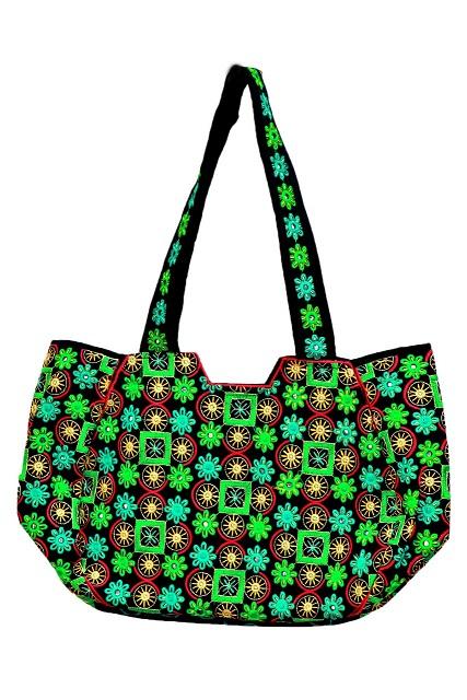 A green handbag made by a Pakistani Woman