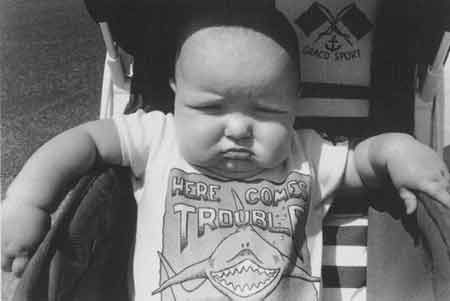 Funny Pictures of Baby with "Here Comes Trouble" Sign